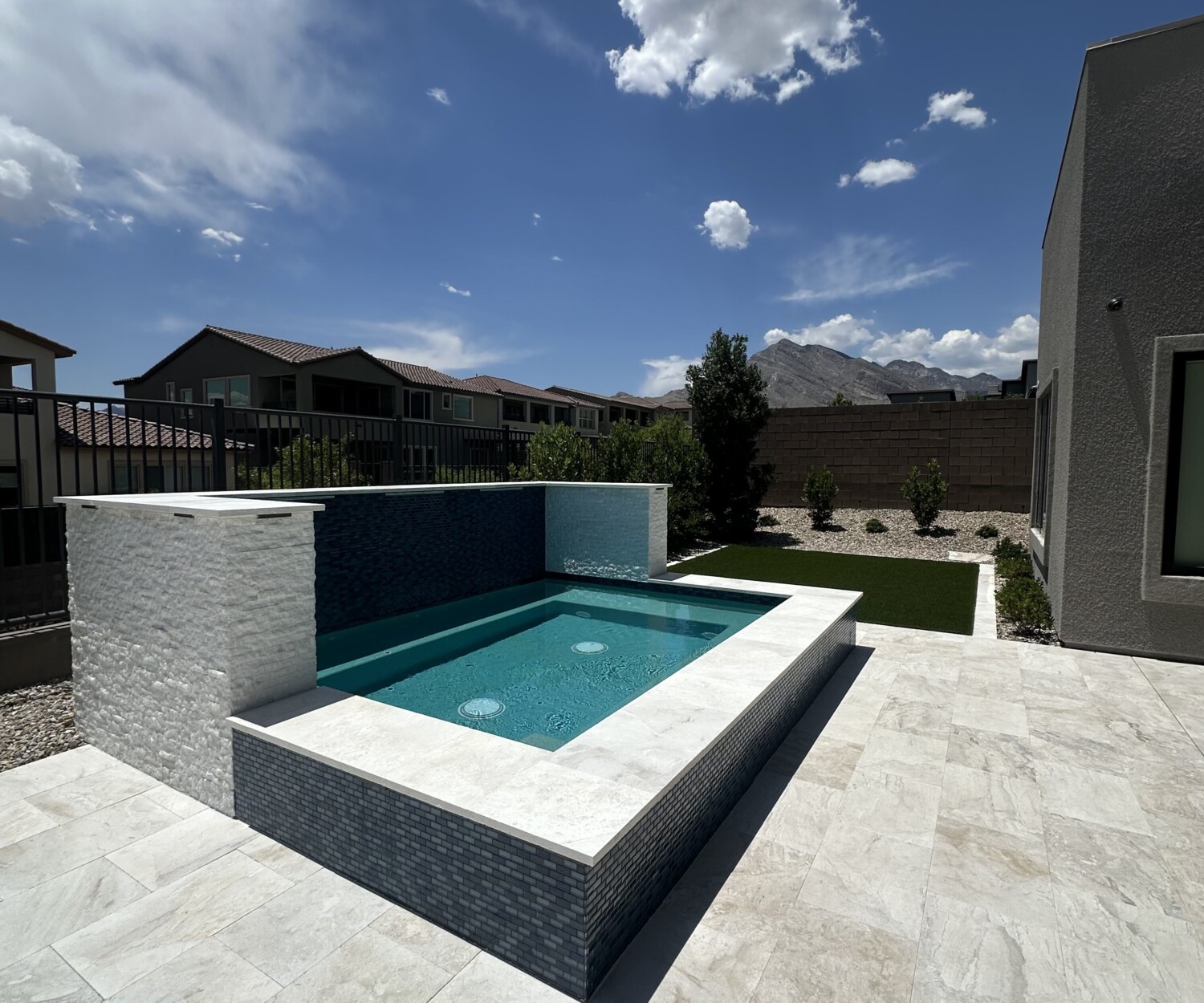 Luxury backyard spa installation in Las Vegas by Aqua Creations, featuring custom tile and integrated seating